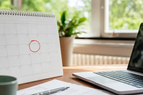 Symbolbild zum Ratgeber „Grundversorgung kündigen: musst du meist gar nicht selbst“: ein Wandkalender mit markiertem Datum neben dem Laptop.